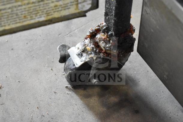 2021 Henny Penny 600 Fryer caster wheel with noticeable grease accumulation. Commercial-grade equipment detail.