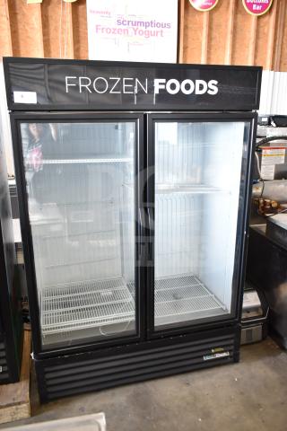 2020 True GDM-49F-HC commercial 2-door freezer merchandiser in good condition. Features "Frozen Foods" signage.