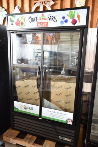 Brand new True TVM-48SL-HC cooler merchandiser, 2-door, commercial use, 115V, 1 phase, minor scratches/dents, visible branding.