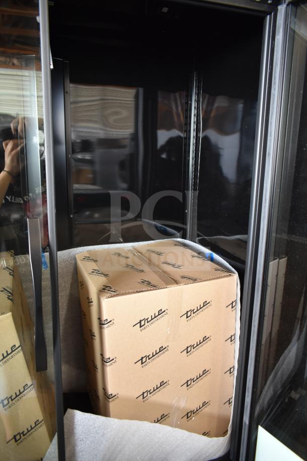 Brand new 2025 True TVM-48SL-HC commercial 2-door reach-in cooler, 115V, with slight cosmetic scratches, packaged in original boxes.
