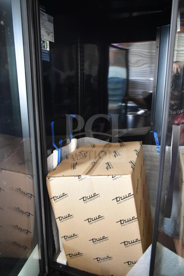 Brand new 2025 True TVM-48SL-HC commercial cooler, 115 volts, 1 phase. Box with True logo visible; scratch and dent noted.