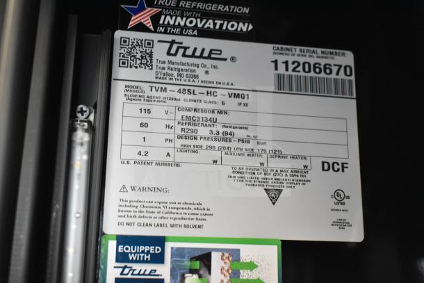 Alt text: Label on True TVM-48SL-HC cooler indicating model, voltage, refrigerant type, and serial number.