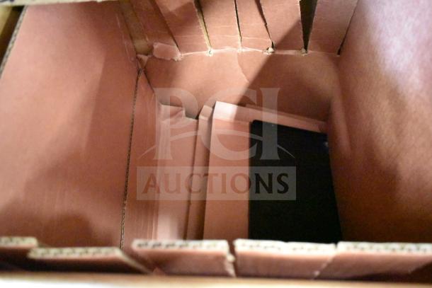 Empty cardboard box with torn edges, possibly packaging for the 2025 True TVM-48SL-HC cooler merchandiser.