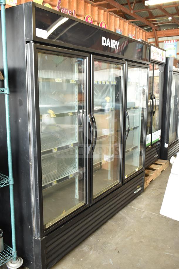 2018 True GDM-72-HC commercial reach-in cooler with three glass doors, black exterior, and dairy signage. 115 volts, 1 phase.