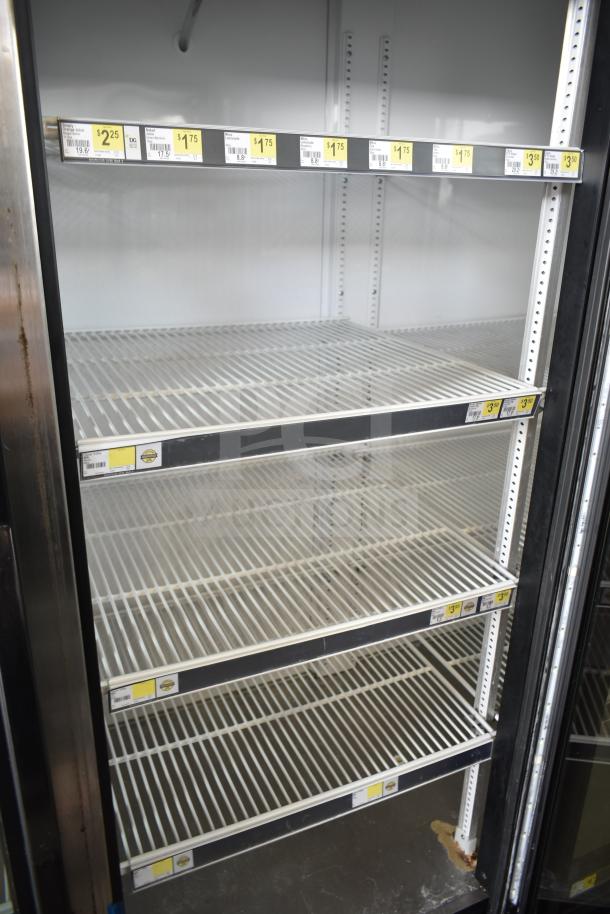 2018 True GDM-72-HC commercial cooler with 3 glass doors, 115 volts, 1 phase. Shelves and price tags visible, in good condition.