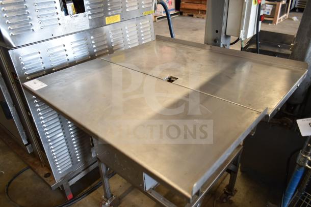 Commercial floor meat saw with stainless steel table, on commercial casters. In good condition, includes operating instructions.
