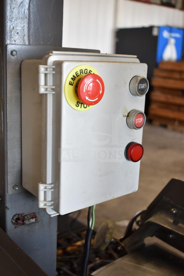 Commercial floor style meat saw with emergency stop, start, and stop controls, mounted on durable commercial casters.