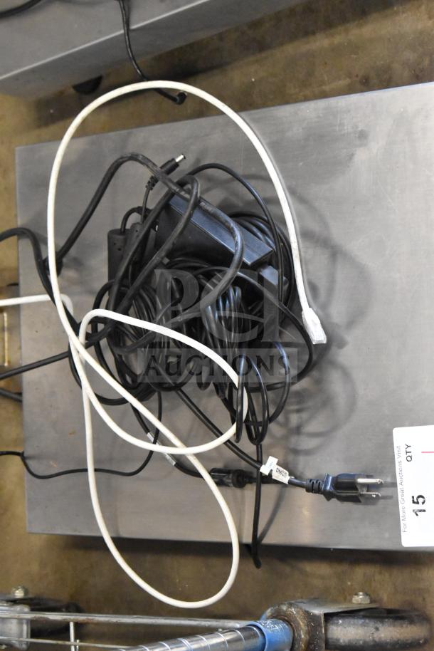 Mettler Toledo ICS4x9-1 Commercial Combi Bench Scale with cables on platform, 100-240V, 1 Phase, metal surface, auction tag visible.