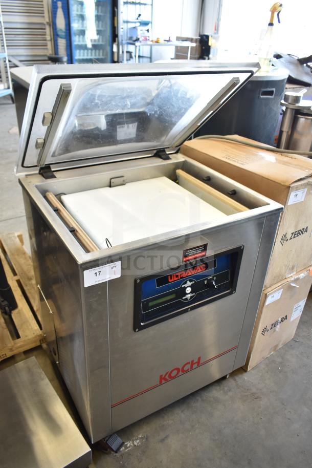 Koch Ultravac UV500 commercial vacuum sealer on casters, 240 volts, 3 phase. Stainless steel, open lid, labeled control panel.
