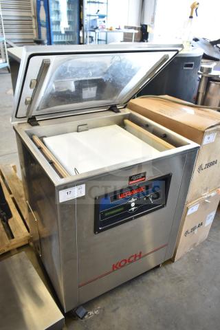 Koch Ultravac UV500 commercial vacuum sealer on casters, 240 volts, 3 phase. Stainless steel, open lid, labeled control panel.