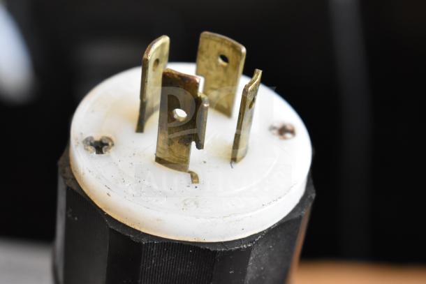 Close-up of a 240V, 3-phase plug for a Koch Ultravac UV500 vacuum sealer, showing metal prongs and white plastic casing.