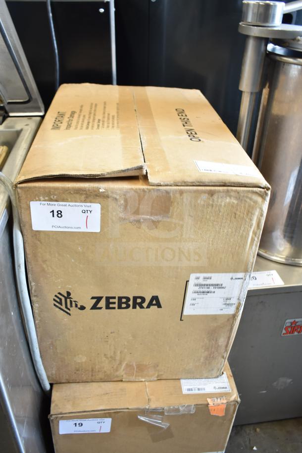 Boxed Zebra ZT41146-T010000Z barcode scanner, new with scratches and dents, showing packaging labels and auction details.