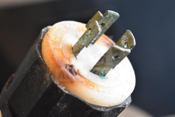 Close-up image of a slightly corroded power plug from a Sirman IS V25 IDRA VERT sausage stuffer, 220 volts.