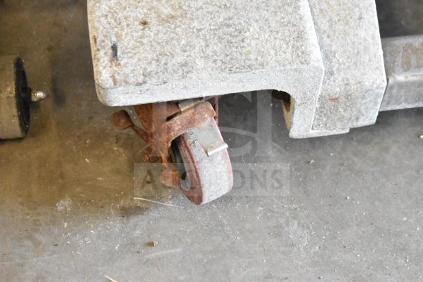 2016 UltraSource Ultravac UY 2100 vacuum sealing machine on commercial casters, 230V, 3-phase. Image shows a close-up of a caster.