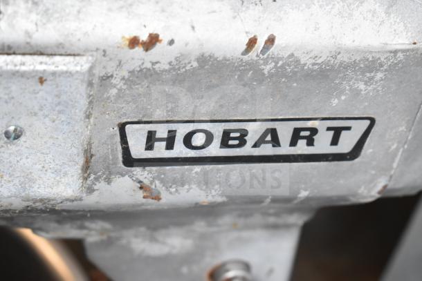 Hobart A-200 mixer label with visible wear; "HOBART" branding on metal surface.