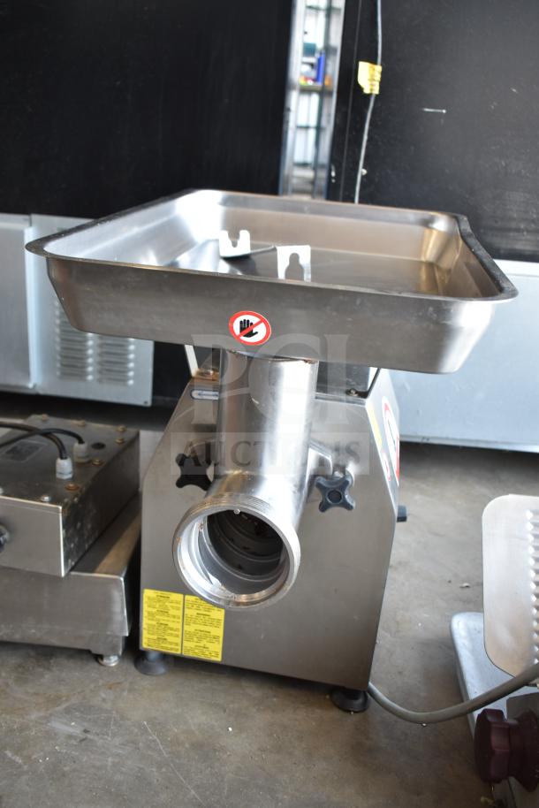 Minerva Omega A/32 commercial countertop meat grinder, 220 volts, 1 phase, stainless steel, with safety and instruction labels.