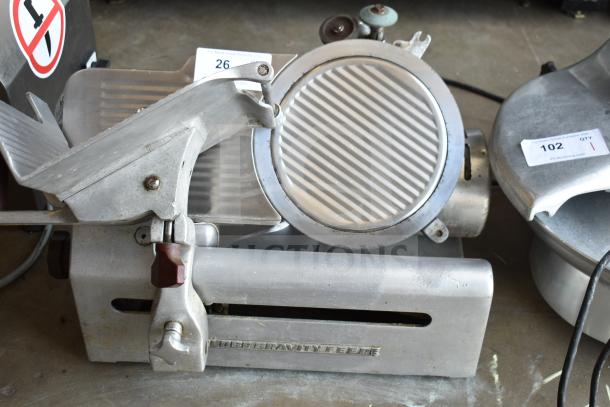 Globe 685 Commercial Meat Slicer with blade sharpener, 115 volts, 1-phase. Visible wear. Auction tags indicate item 26, QTY 1.