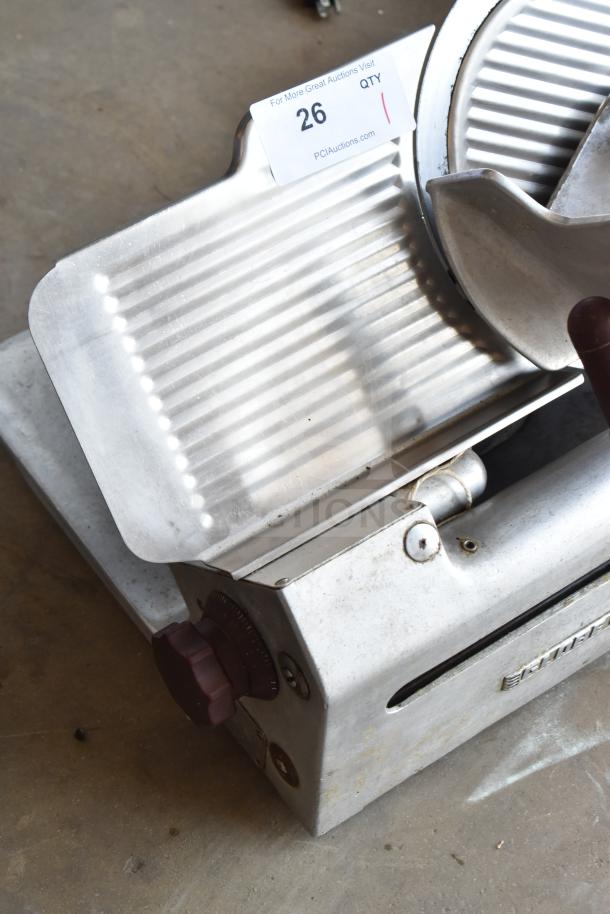 Globe 685 commercial countertop meat slicer with blade sharpener, 115 volts, 1 phase, includes auction tag.