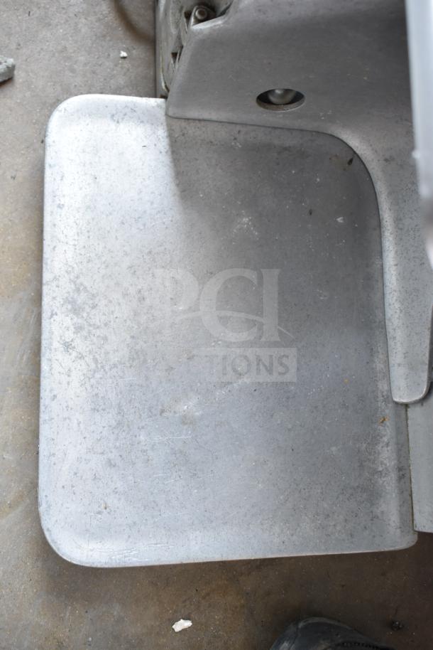 Globe 685 commercial meat slicer, countertop model with blade sharpener. Metal surface shows wear. Operates at 115V, 1 Phase.