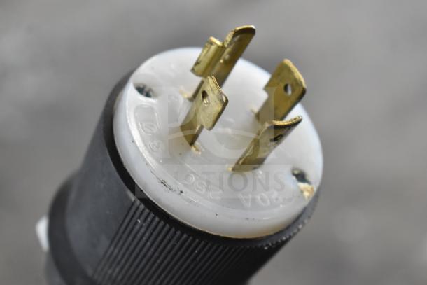 Close-up of a plug from Sirman TC 42 MONTANA electric meat grinder. Visible markings show "320 AMPS 250 VOLTS."