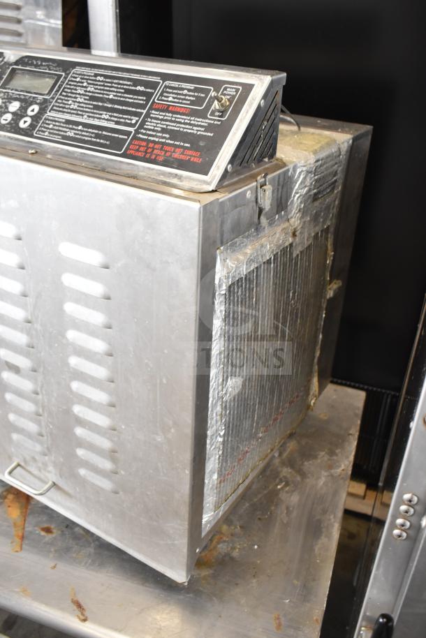 TSM Products Commercial Countertop Dehydrator with digital control panel, stainless steel exterior, visible wear, and vented sides.