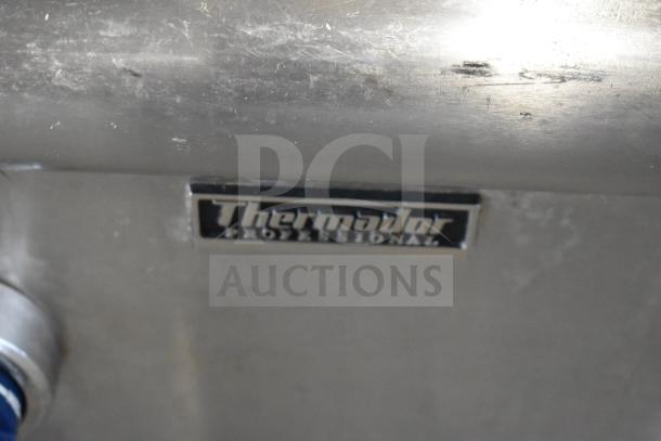 Thermador commercial countertop gas range, 4 burners, charbroiler, flat top griddle. Visible logo and stainless steel finish.