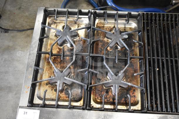 Thermador commercial countertop gas range with 4 burners, charbroiler, and griddle. Used condition with visible wear.