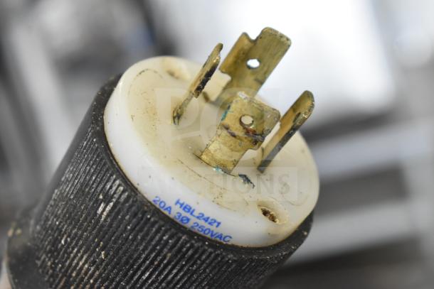 Close-up of Biro 3334 commercial meat saw plug, showing 208/240V marking, slight wear, sturdy brass prongs.