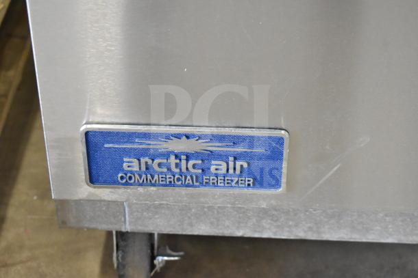 Arctic Air AUC27FZ single door undercounter freezer on casters, commercial-grade, 115 volts, visible brand label.