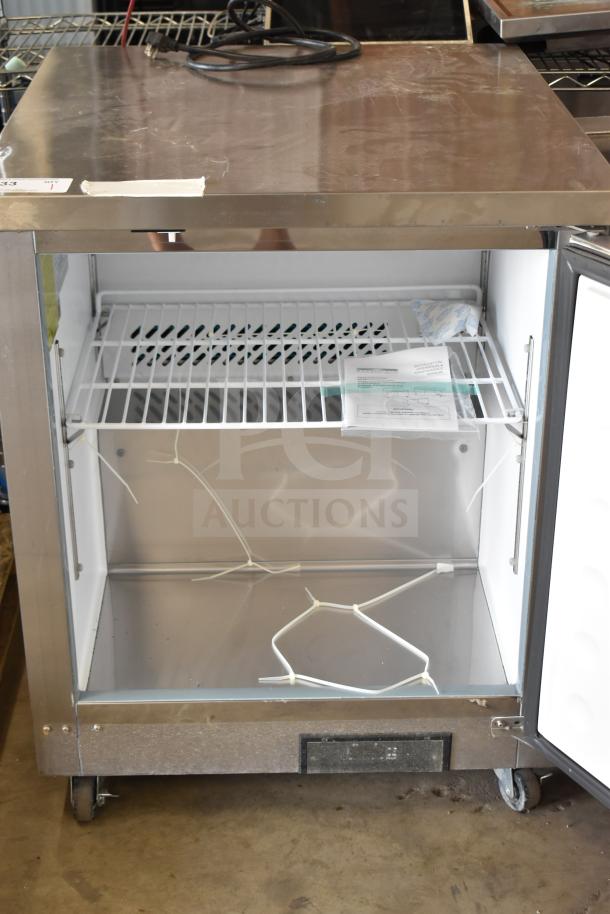 Arctic Air AUC27FZ undercounter freezer with single door, commercial casters, 115 volts, 1 phase, in good condition.