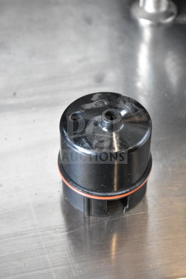 Clover 1S coffee brewer component, black plastic, red gasket, part of automated single-cup system, countertop use.