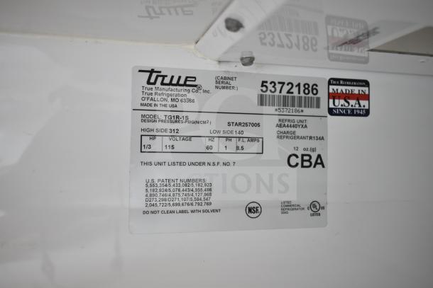 True TG1R-1S commercial cooler data plate showing model, 115 volts, 1 phase, NSF certified, Made in USA.