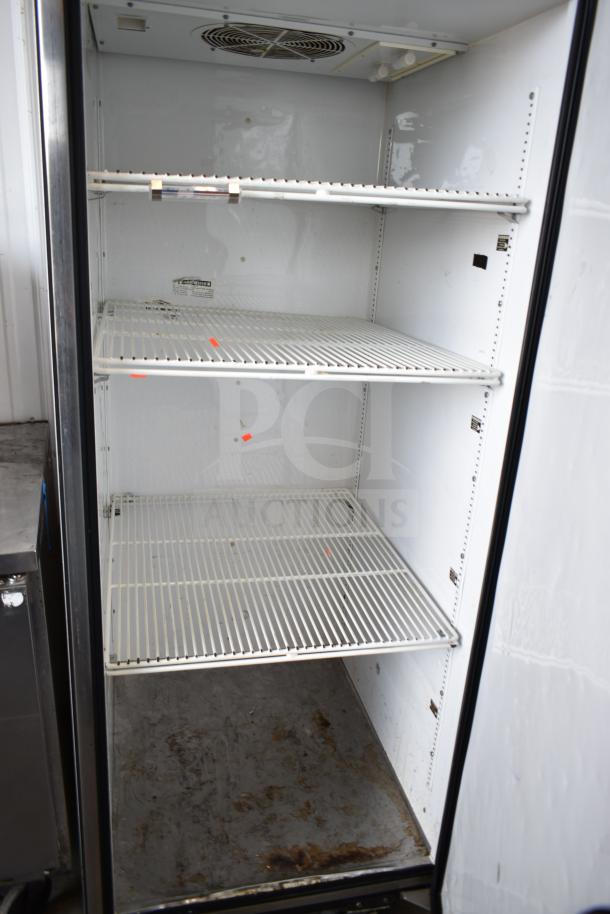 True TG1R-1S commercial single door reach-in cooler, on casters, 115 volts, 1 phase, interior shelves, visible wear.