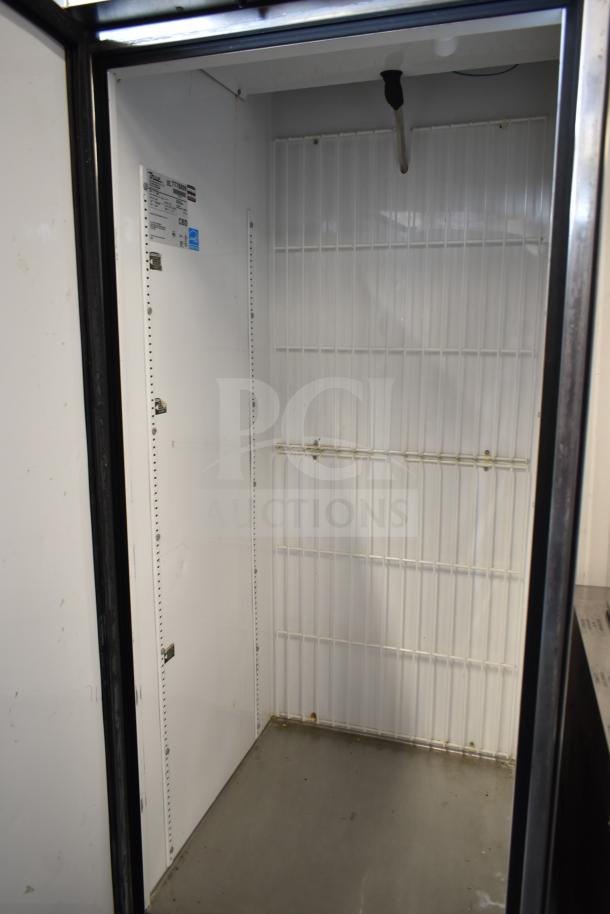 True T-23F single door commercial freezer, white interior, on casters. Features 115 volts, 1 phase, with visible True label.