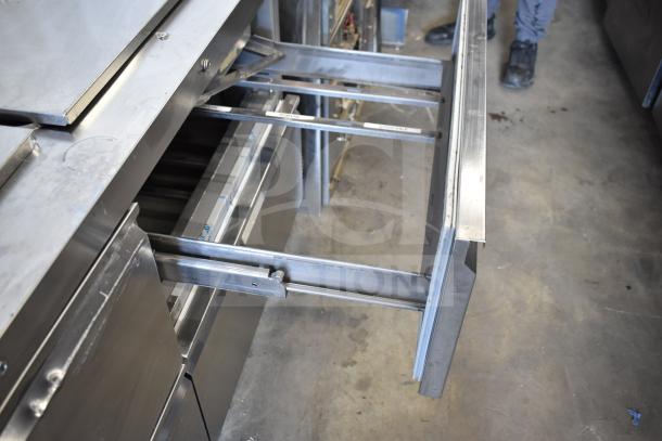 2020 Delfield D4460NP-24M-A5 commercial prep table with 4 drawers, open drawer view, on commercial casters, 115V.