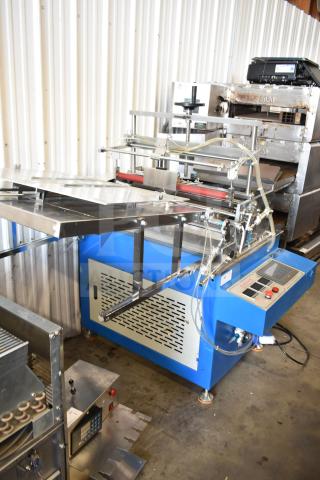 Commercial floor-style paper tube labeling machine with controls, on casters. 208/240V, 1 phase, in good condition.
