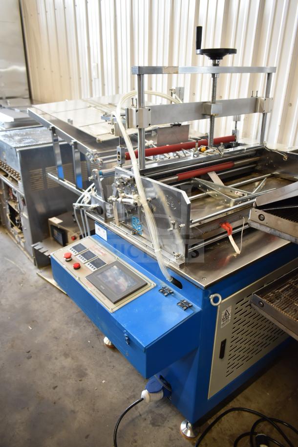 Commercial floor-style paper tube labeling machine on casters. Blue and steel, 208/240 volts, 1 phase, control panel visible.