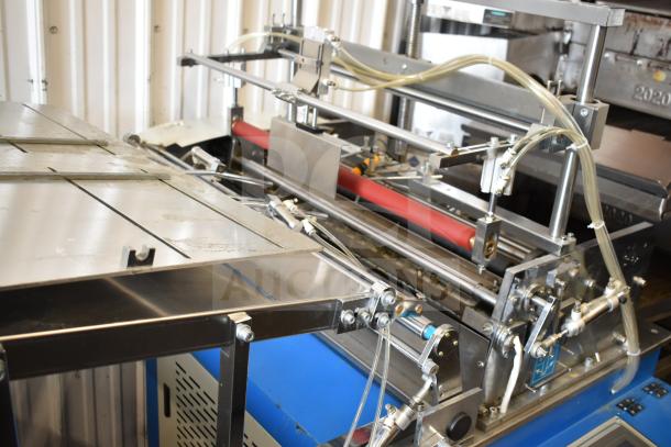 Commercial floor-style paper tube labeling machine on casters, 208/240 volts, 1 phase, with visible metal components and tubing.