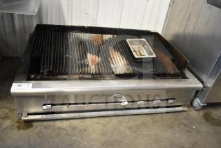 Wells Commercial Countertop Gas Charbroiler Grill in used condition. Features adjustable burners and comes with a drip tray.