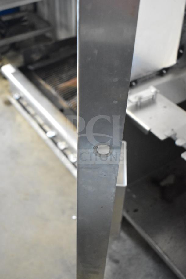 JBT 2ND-GEN-MFJ-HE citrus juicer, commercial floor style, showing a metal component on casters, 115V, 1 Phase.