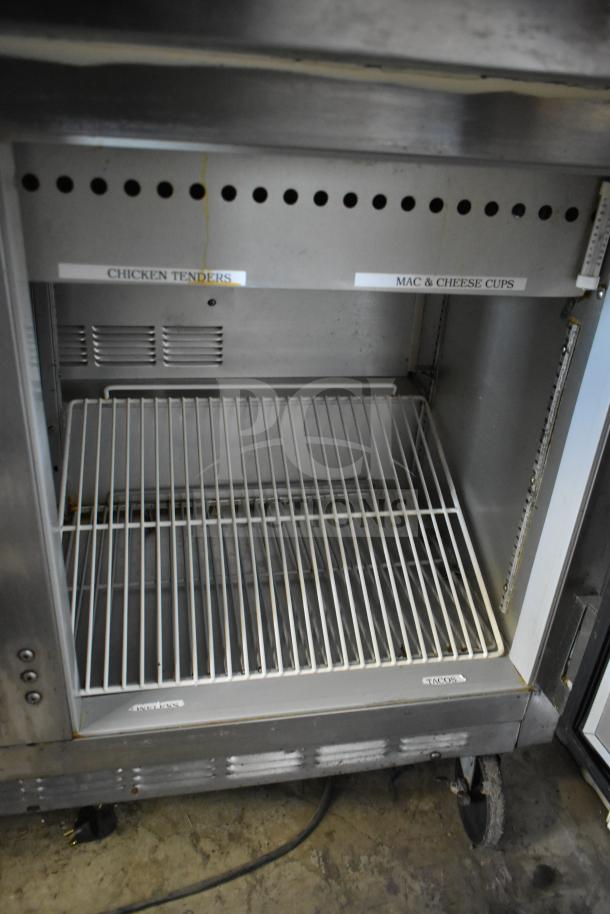 Beverage Air commercial sandwich salad prep table featuring interior wire shelving, labeled sections, commercial casters.