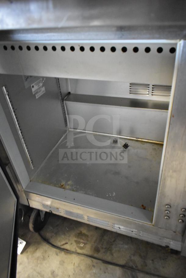 Beverage Air commercial sandwich salad prep table with mega top, on casters. Interior view, shows used condition. 115V, 1 Phase.