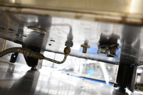 Underside of Bunn DUAL SH DBC coffee machine showing piping and fittings. 120/208V, 1 Phase, commercial model.