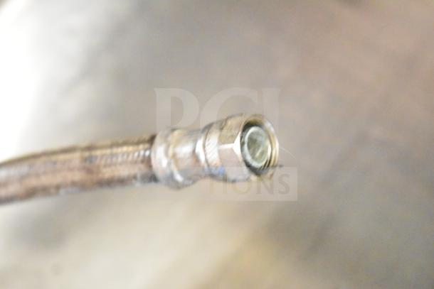 Close-up of a metal connector for a Bunn DUAL SH DBC coffee machine. Image shows the connector's threading and metal texture.