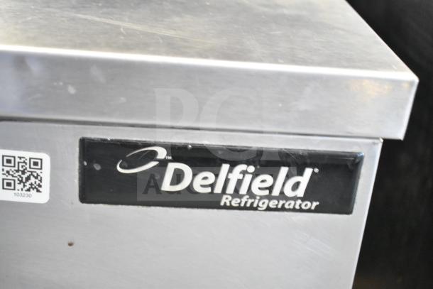Delfield Commercial 2 Door Undercounter Cooler, stainless steel finish, 115 volts, 1 phase, close-up of logo and QR code.