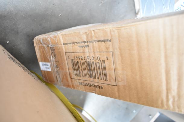 Cardboard box labeled "ServIt 423SW54TCPA Strip Warmer." Box shows scratches and dents. Barcode visible.