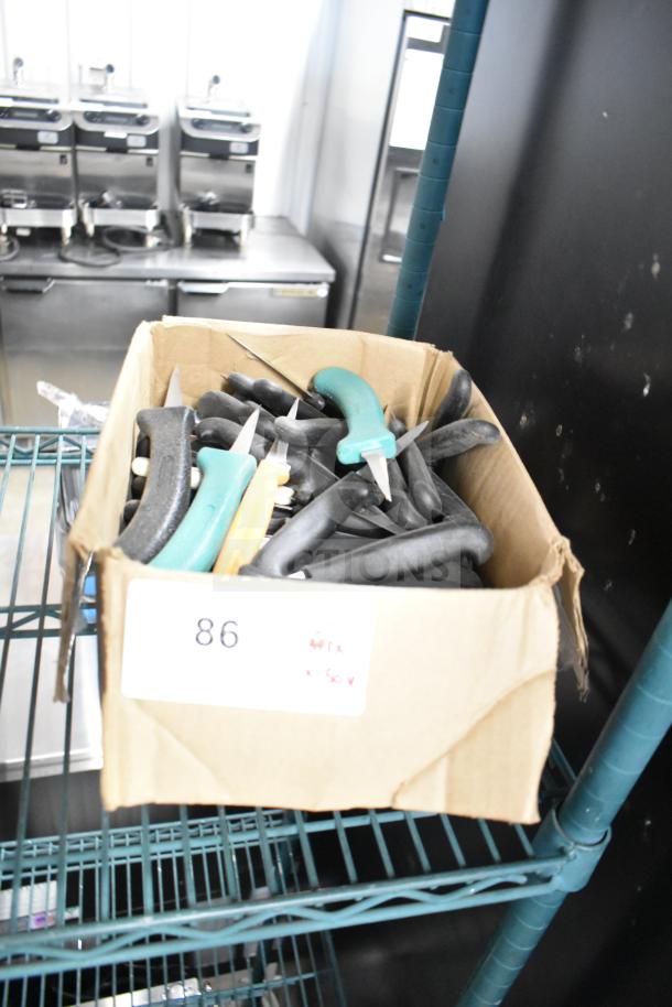 Box of 50 sharpened stainless steel poultry knives, mixed handle colors, auction tag reading "86".