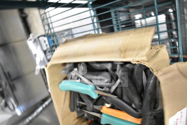 Box of 50 sharpened stainless steel poultry knives with black and colored handles, in good condition.