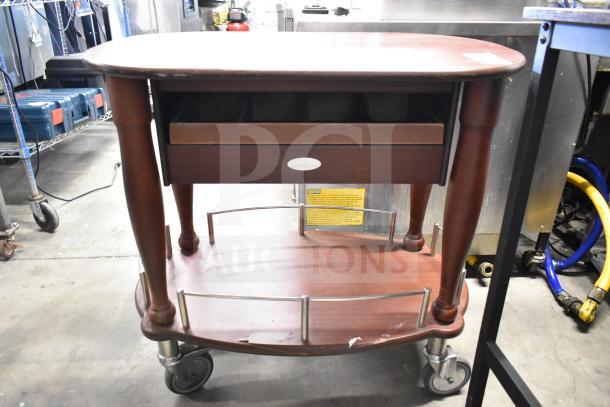 Geneva Wooden Table with under shelf, commercial casters, minor scratches; label visible on front.