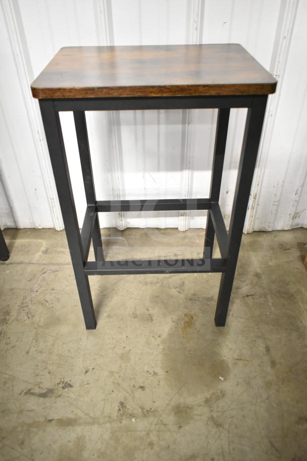 Modern wood-patterned table with black metal frame, bar height. Part of 24-unit auction including tables and stools.